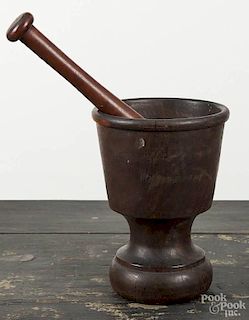 Two walnut and lignum vitae mortar and pestles, 18th c., 10'' h. and 13'' h.