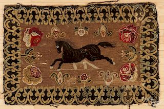 Hooked rug with a jumping horse, early 20th c., and a floral background, 58'' x 37''.
