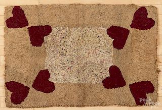 Hooked rug with heart corners, early 20th c., 38'' x 25 1/2''.