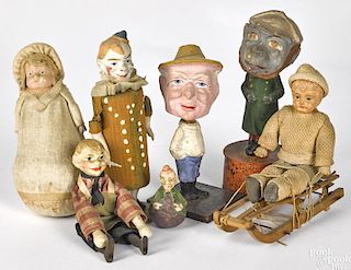 Seven composition and celluloid toy figures