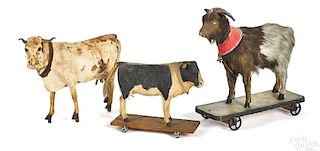 Two composition cow platform pull toys
