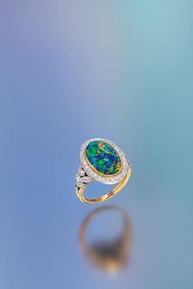 An Edwardian Platinum Topped Gold, Black Opal and Diamond Ring, Marcus & Co., 4.80 dwts.