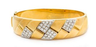 An 18 Karat Bicolor Gold and Diamond Bangle Bracelet, 35.30 dwts.