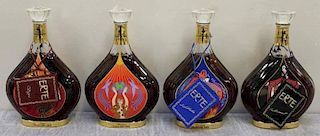 Set of 4 Erte Courvoisier Cognac Bottles.