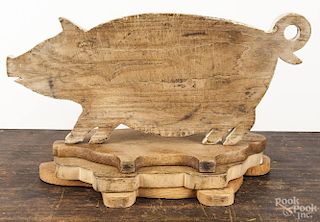 Four wooden cut out pig cutting boards, 20th c., largest - 21'' l.