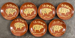Seven Lester Breininger redware plates, signed and dated 1997, with sheep decoration, 7'' dia.