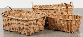 Three split oak gathering baskets 20th c., largest - 12'' h., 22 1/2'' w.