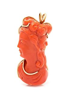A 14 Karat Yellow Gold and Carved Coral Pendant, 7.70 dwts.