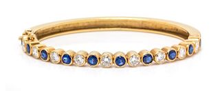 An 18 Karat Yellow Gold, Sapphire and Diamond Bangle Bracelet, 17.20 dwts