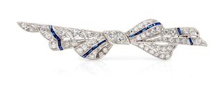 An Art Deco Platinum, Diamond and Sapphire Bow Brooch, 5.00 dwts.