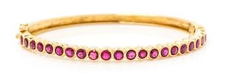 A Yellow Gold and Ruby Bangle Bracelet, 11.50 dwts.