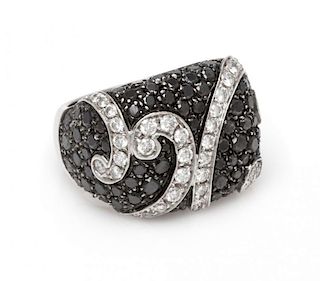 An 18 Karat White Gold, Black Diamond and Diamond Ring, 11.60 dwts.