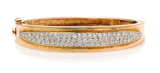 A 14 Karat Bicolor Gold and Diamond Bangle Bracelet, 12.90 dwts.