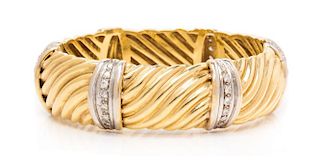 An 18 Karat Bicolor Gold and Diamond Bangle Bracelet, 43.70 dwts.