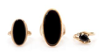 A Collection of Yellow Gold and Onyx Rings, 11.30 dwts.