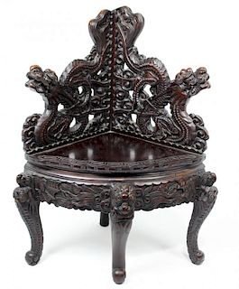 CHINESE CARVED AND EBONIZED CORNER CHAIR