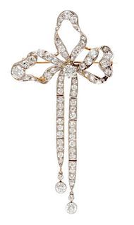 An Edwardian Platinum Topped Gold and Diamond Bow Brooch, 7.80 dwts.