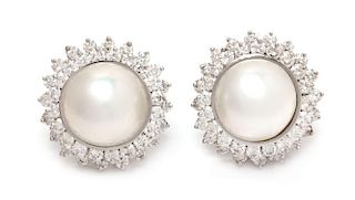 A Pair of 18 Karat White Gold, Mabe Pearl and Diamond Earclips, 11.60 dwts.