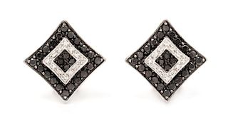A Pair of 14 Karat White Gold Black Diamond and Diamond Earclips, 4.70 dwts.