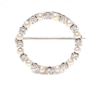 A 14 Karat White Gold, Diamond and Cultured Pearl Circle Brooch, 2.60 dwts.