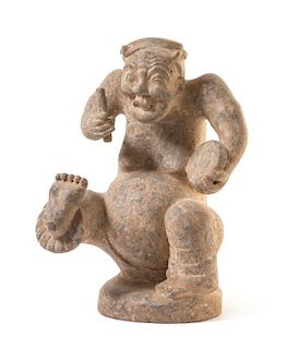 A Red Pottery Figure of a Drummer