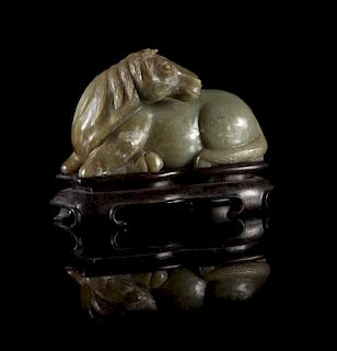 A Carved Celadon Jade Figure of a Recumbent Horse