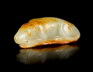 A Carved White and Russet Jade Figure of a Dog