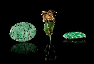 Three Jadeite and Yellow Gold Mounted Brooches Length of largest 1 3/4 inches.