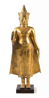 A Thai Gilt Bronze Figure of Standing Buddha Height 49 1/4 inches.