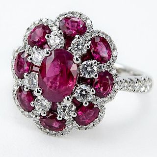 Approx. 2.08 Carat TW Oval Cut Ruby, .65 Carat Round Brilliant Cut Diamond and 18 Karat White Gold Ring, set in the Center wi