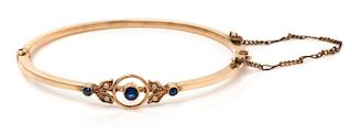 An Edwardian Rose Gold, Sapphire and Faux Pearl Child's Bangle Bracelet, 1.80 dwts.