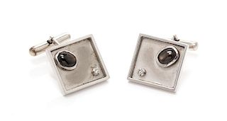 A Pair of White Gold, Black Star Sapphire and Diamond Cufflinks, 8.80 dwts.
