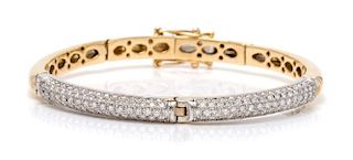 An 18 Karat Bicolor Gold and Diamond Bangle Bracelet, 16.50 dwts.