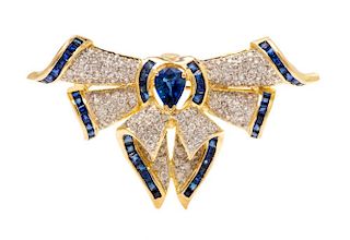 A 14 Karat Yellow Gold, Sapphire and Diamond Bow Motif Pendant/Brooch, 5.20 dwts.