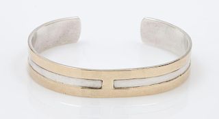 A Sterling Silver and 14 Karat Yellow Cuff Bracelet, M&J Savitt, 12.80 dwts.