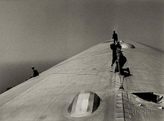 Alfred Eisenstaedt (American, 1898-1995)      Repairing the Hull of the Graf Zeppelin During the Flight over the Atlantic