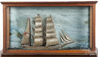 Carved and painted ship model in a shadowbox