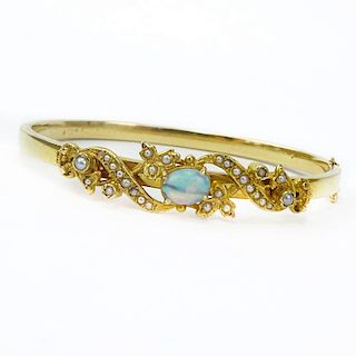 Vintage 14 Karat Yellow Gold Bangle Bracelet set with an Oval Cut Opal and Seed pearls.