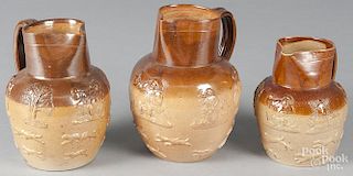 Three salt glaze stoneware pitchers