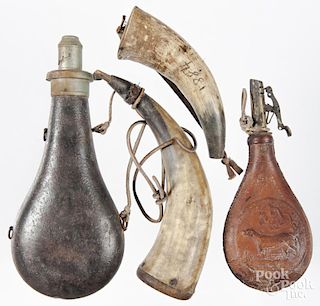 Two powder horns, together with two flasks.