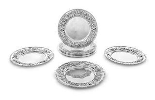 * A Set of Eight American Silver Bread Plates, S. Kirk & Son, Baltimore, MD, each having a repousse floral and foliate border