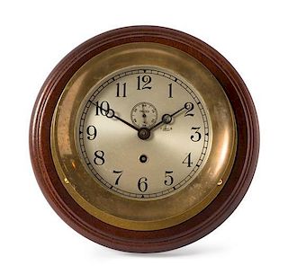 A Chelsea Brass Ship's Clock Diameter 9 1/2 inches.