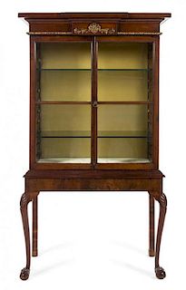 * A Queen Anne Style Parcel Gilt Mahogany Vitrine Cabinet Height 70 x width 37 1/4 x depth 14 3/4 inches.