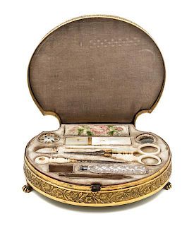 * A Palais Royal Gilt Metal Mounted Tortoise Shell Sewing Kit, , the scallop form case having a tortoise shell inset lid with