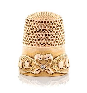 * An American 14-Karat Gold and Diamond Thimble, Goldsmith, Stern & Co., New York, NY, the knurled top and body above a ribbo