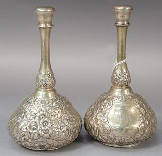 Pair of sterling silver cologne bottle with repousse bodies, monogrammed (dents). 
ht. 7 3/4in. 
11.8 troy ounces