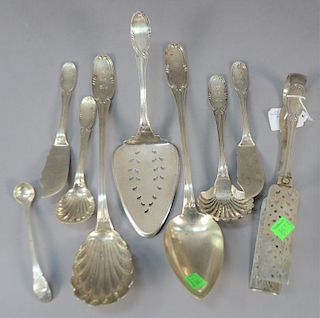 Ten piece coin silver lot including Jones Ball & Poor fish server, pie server, tongs, and serving spoons. 
34 troy ounces