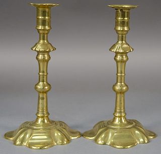 Pair of George III brass candlesticks having turned shaft on petal foot base.  ht. 8 1/2in.  Provenance:  Estate of Arthur C.