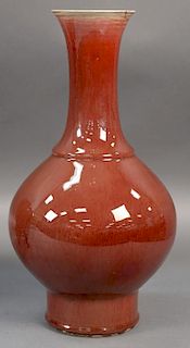 Chinese Sang de Boeuf glazed globular vase, oxblood with white rim having trumpet neck and bulbous body on circular footed ba