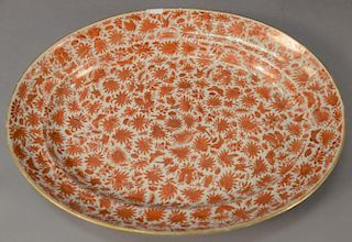Famille Rose oval platter having painted mandarin and gilt flowers, butterflies, and birds (chip on rim).  18 1/2" x 14 1/2"